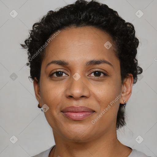 Joyful black young-adult female with short  brown hair and brown eyes