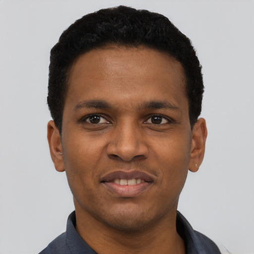 Joyful black young-adult male with short  black hair and brown eyes
