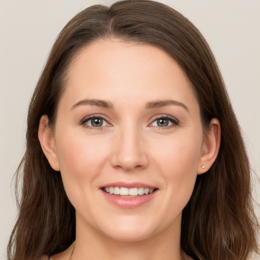 Joyful white young-adult female with long  brown hair and grey eyes