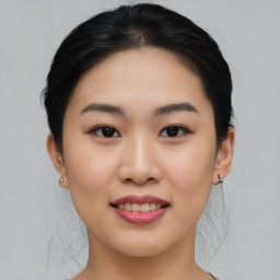 Joyful asian young-adult female with medium  black hair and brown eyes