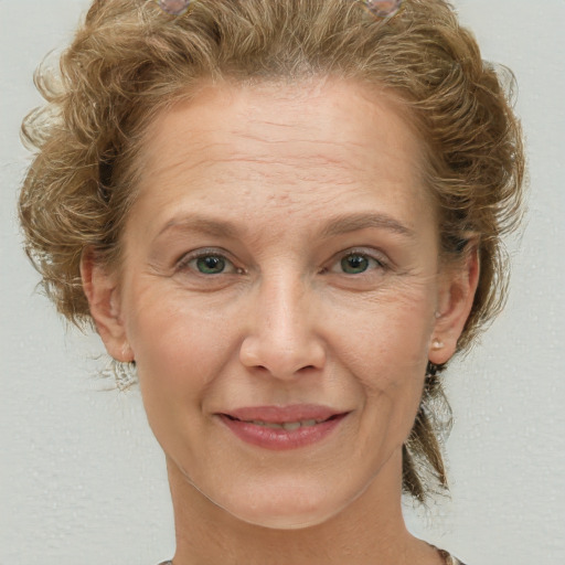 Joyful white adult female with short  brown hair and grey eyes