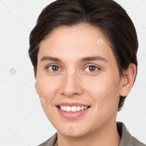 Joyful white young-adult female with short  brown hair and brown eyes