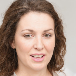 Joyful white young-adult female with medium  brown hair and green eyes