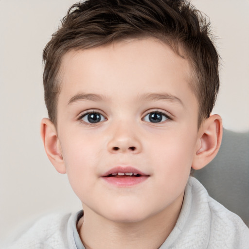 Joyful white child male with short  brown hair and brown eyes