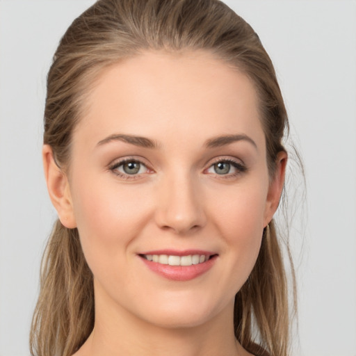 Joyful white young-adult female with long  brown hair and grey eyes