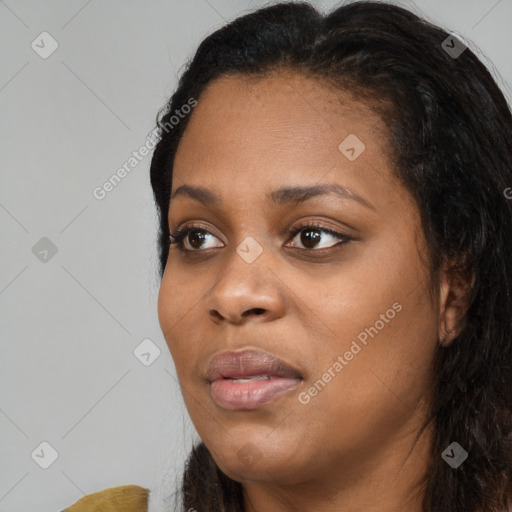 Joyful black young-adult female with long  black hair and brown eyes