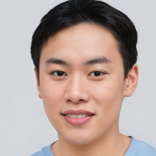 Joyful asian young-adult male with short  black hair and brown eyes