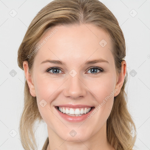 Joyful white young-adult female with long  brown hair and blue eyes