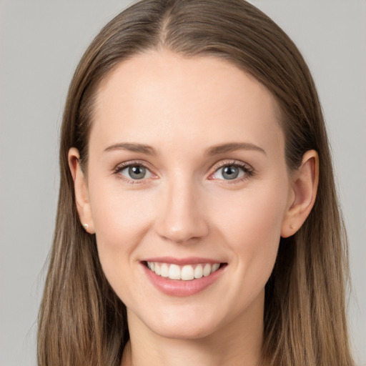 Joyful white young-adult female with long  brown hair and grey eyes