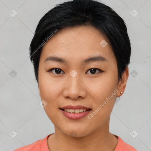 Joyful asian young-adult female with short  black hair and brown eyes