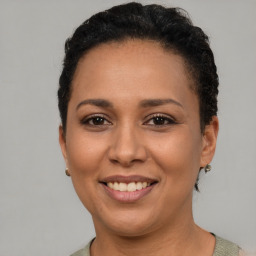 Joyful latino young-adult female with short  brown hair and brown eyes