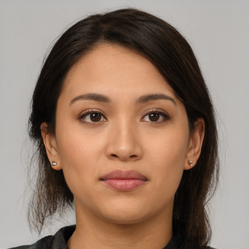 Joyful latino young-adult female with long  brown hair and brown eyes