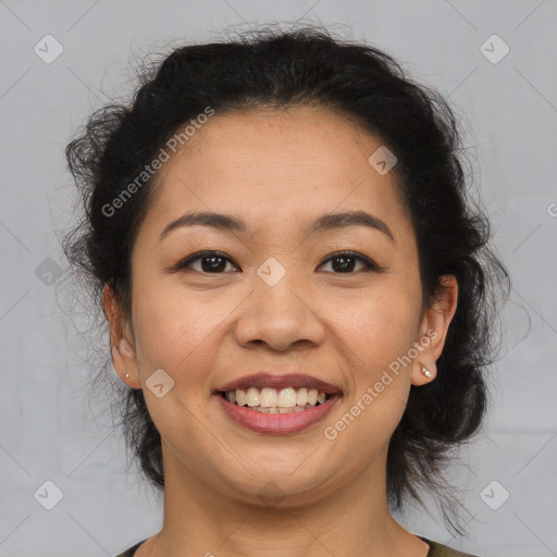 Joyful latino adult female with medium  brown hair and brown eyes