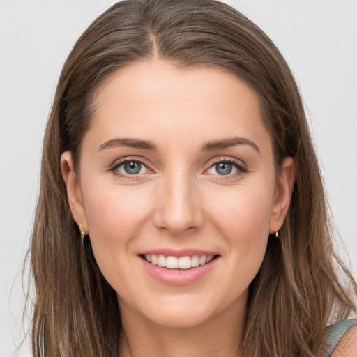 Joyful white young-adult female with long  brown hair and grey eyes