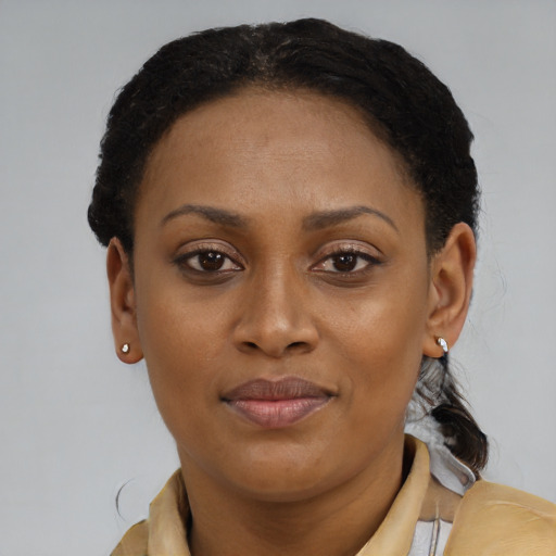 Joyful black young-adult female with short  brown hair and brown eyes