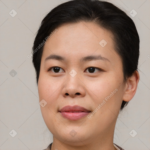 Joyful asian young-adult female with short  brown hair and brown eyes