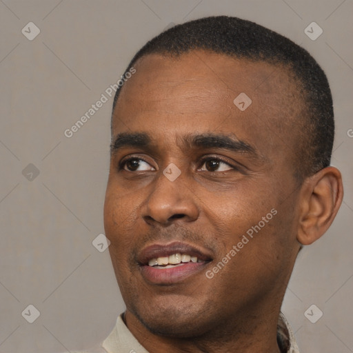 Joyful black young-adult male with short  black hair and brown eyes