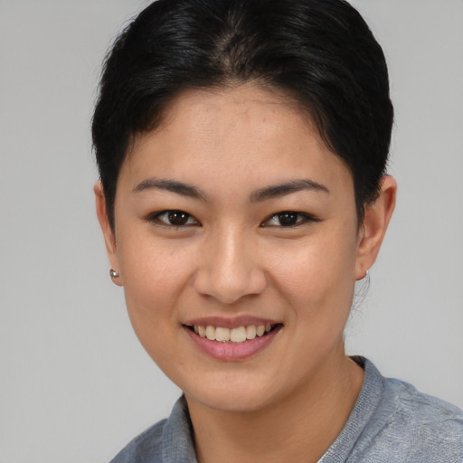 Joyful asian young-adult female with short  brown hair and brown eyes