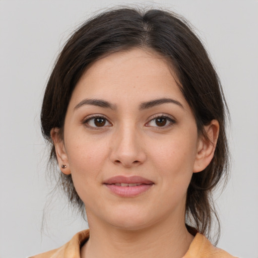 Joyful white young-adult female with medium  brown hair and brown eyes