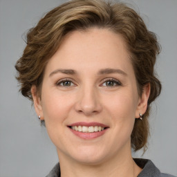 Joyful white young-adult female with medium  brown hair and grey eyes