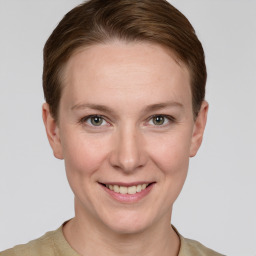 Joyful white young-adult female with short  brown hair and grey eyes