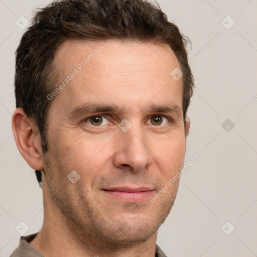 Joyful white adult male with short  brown hair and grey eyes