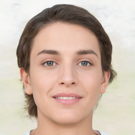 Joyful white young-adult female with medium  brown hair and green eyes