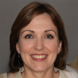 Joyful white adult female with medium  brown hair and brown eyes