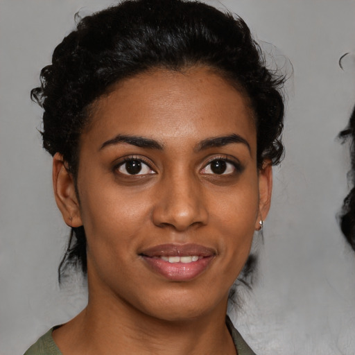 Joyful black young-adult female with short  brown hair and brown eyes