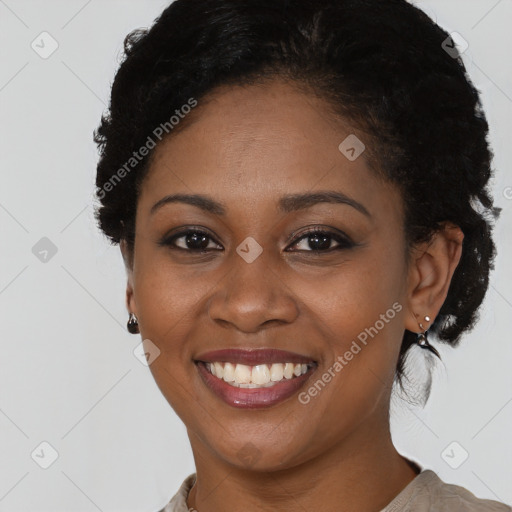 Joyful black young-adult female with short  black hair and brown eyes