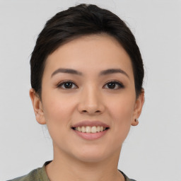 Joyful asian young-adult female with short  brown hair and brown eyes