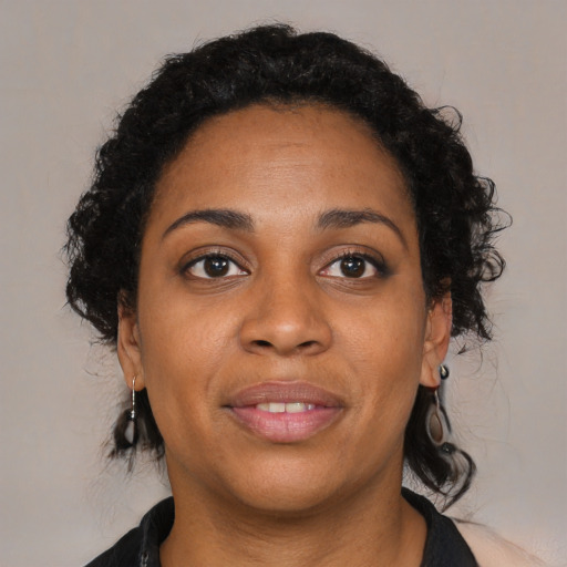 Joyful black young-adult female with medium  brown hair and brown eyes