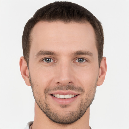 Joyful white young-adult male with short  brown hair and brown eyes