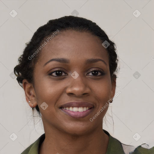 Joyful black young-adult female with long  black hair and brown eyes