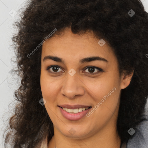 Joyful black young-adult female with long  brown hair and brown eyes