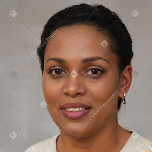 Joyful black young-adult female with short  black hair and brown eyes