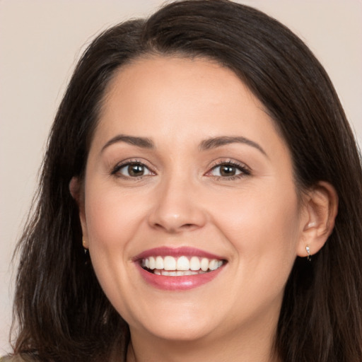 Joyful white young-adult female with long  brown hair and brown eyes