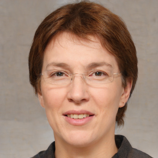 Joyful white adult female with medium  brown hair and brown eyes