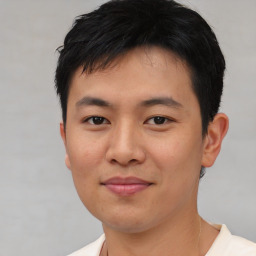 Joyful asian young-adult male with short  black hair and brown eyes