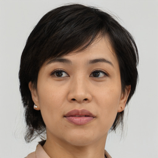 Joyful asian young-adult female with medium  black hair and brown eyes