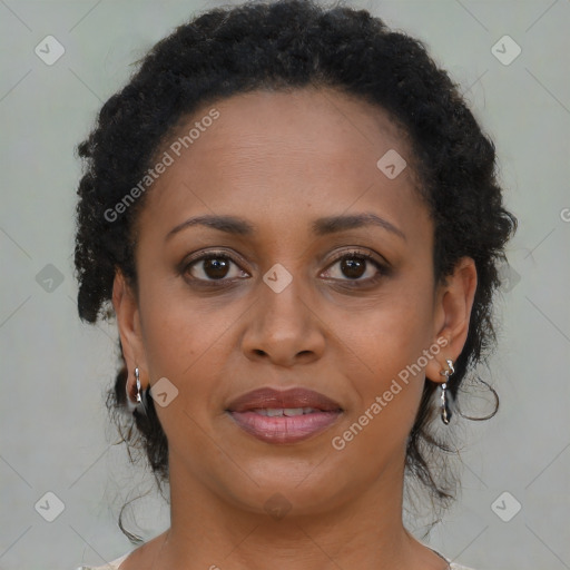 Joyful black adult female with medium  brown hair and brown eyes