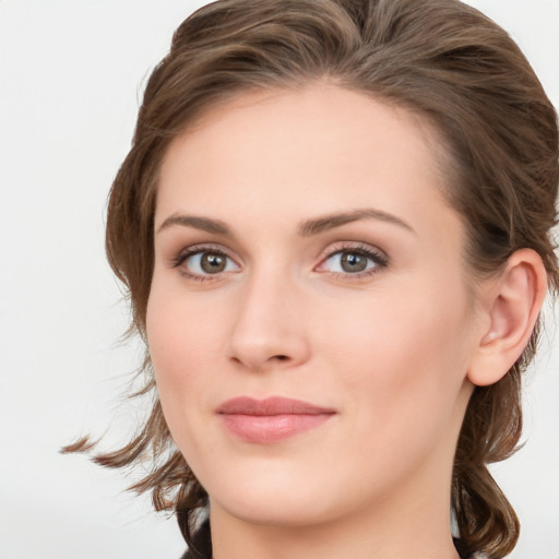 Joyful white young-adult female with medium  brown hair and blue eyes