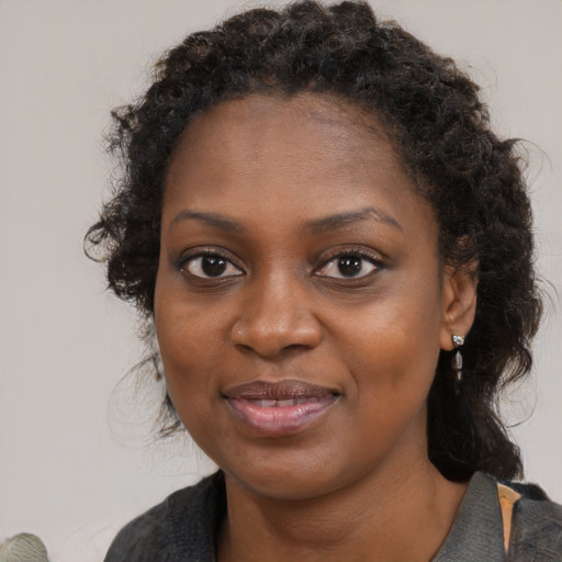 Joyful black young-adult female with medium  brown hair and brown eyes