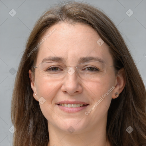 Joyful white adult female with long  brown hair and grey eyes