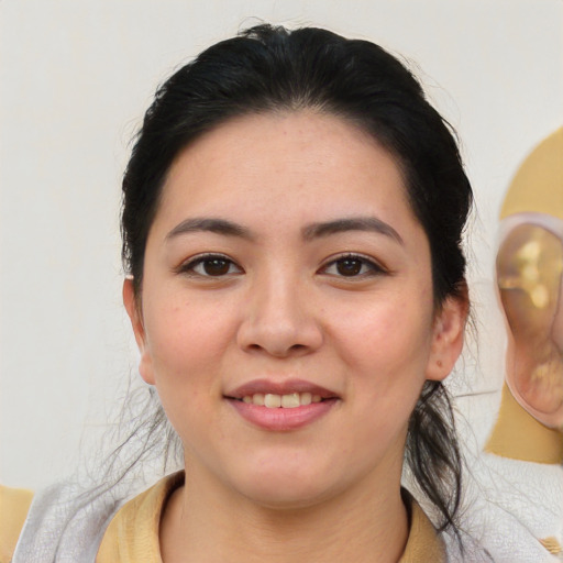 Joyful latino young-adult female with medium  brown hair and brown eyes