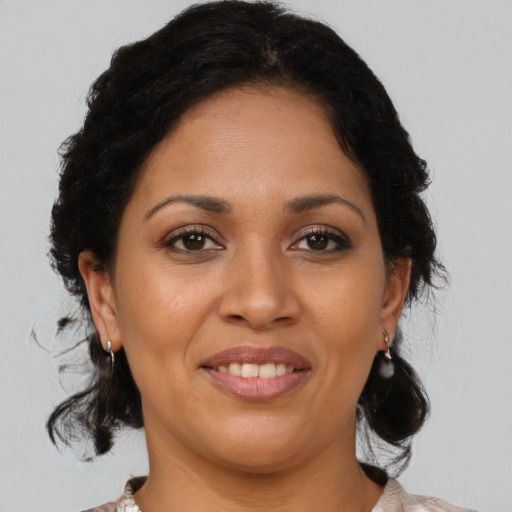 Joyful latino adult female with medium  brown hair and brown eyes