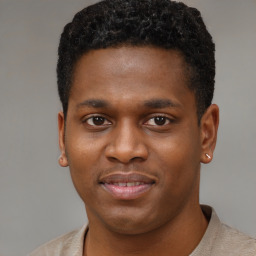 Joyful black young-adult male with short  brown hair and brown eyes