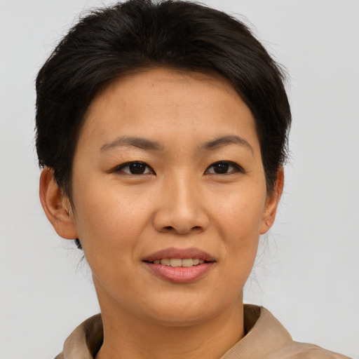 Joyful asian young-adult female with short  brown hair and brown eyes