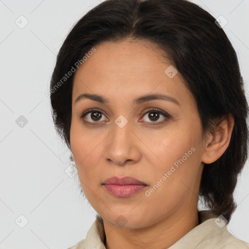 Joyful latino adult female with medium  brown hair and brown eyes