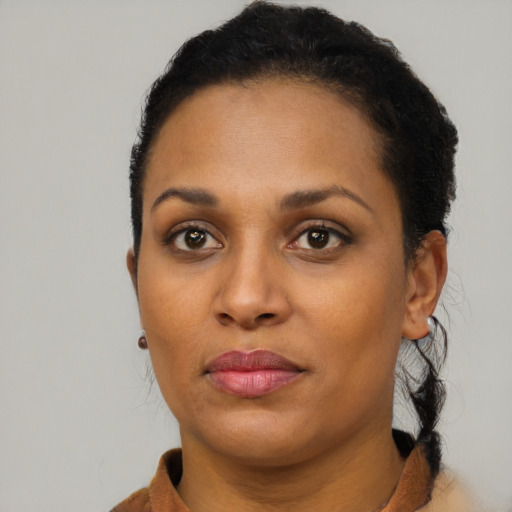 Joyful black young-adult female with short  brown hair and brown eyes